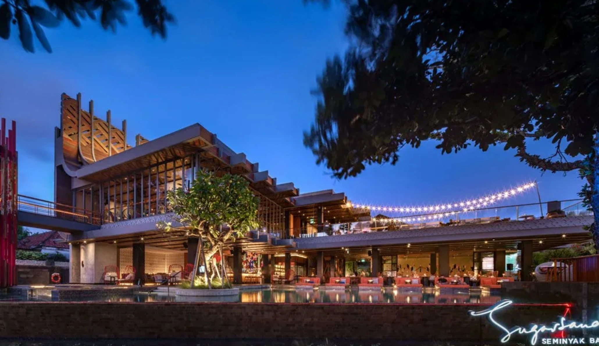 SugarSand rooftop bar overlooking Seminyak Beach at sunset